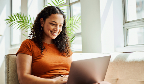 Woman smiling while using laptop
