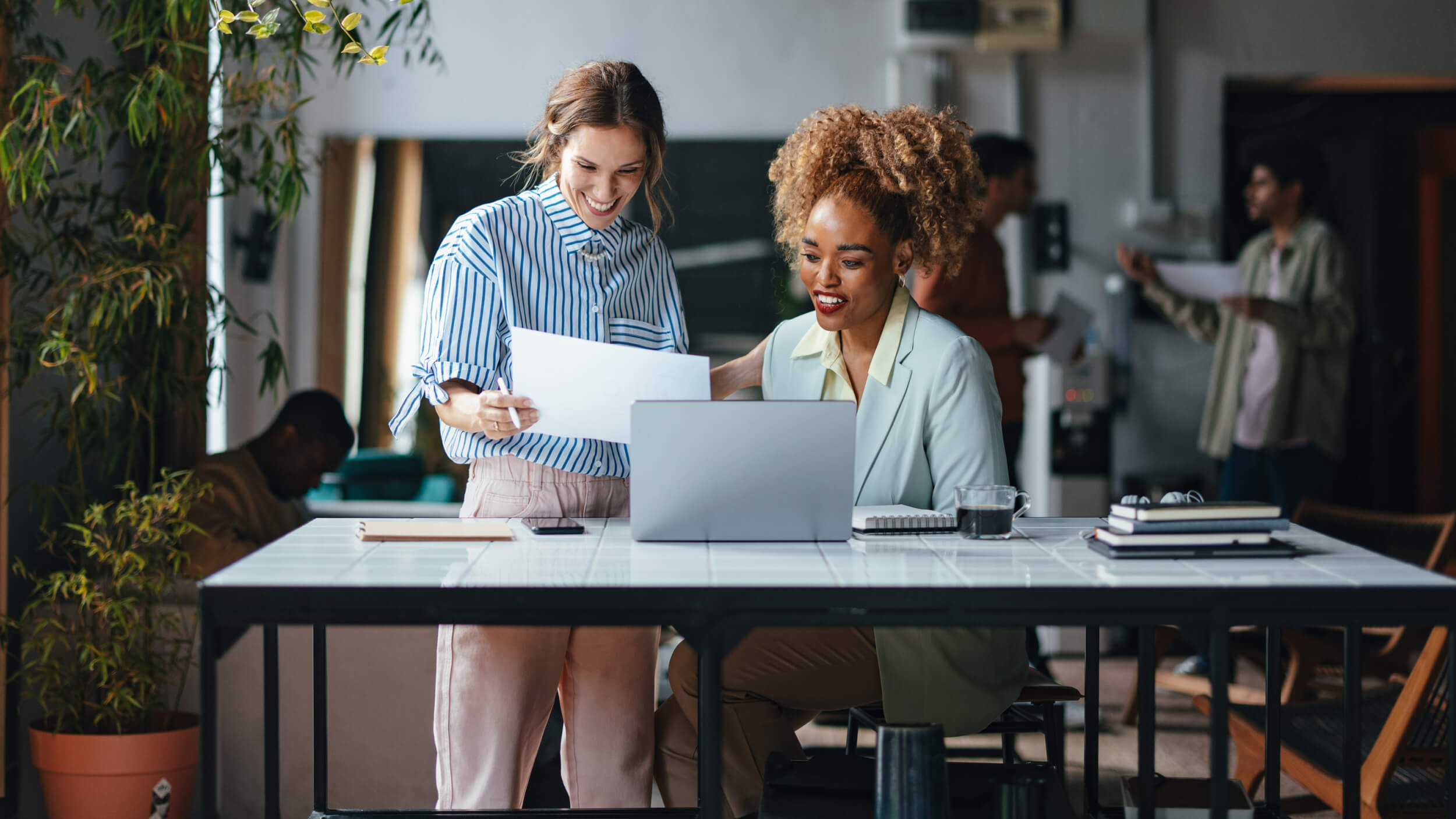 Women at desk looking at documents